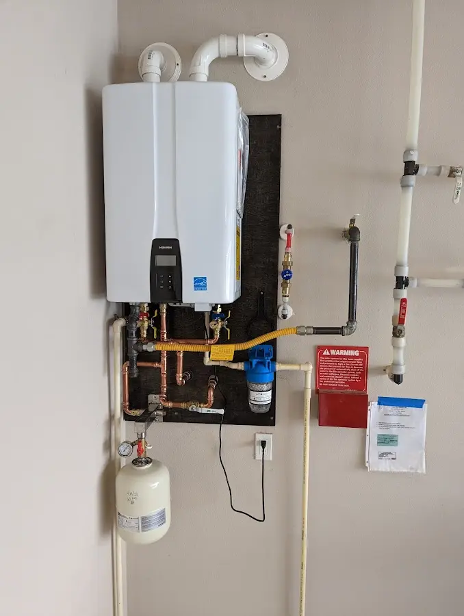 Professional plumber installing copper piping in a Richland Center home